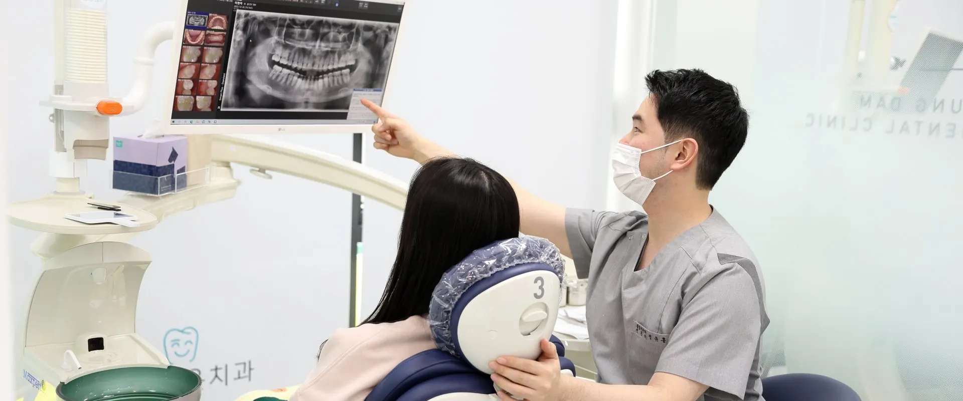 엑스레이 사진으로 임플란트 치료를 설명하는 모습